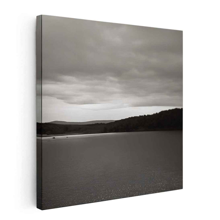 Slate Waterside Drama: Monochrome Landscape of Serene Waters and Brooding Skies
