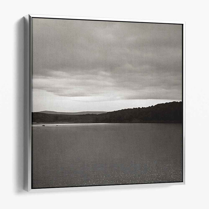Slate Waterside Drama: Monochrome Landscape of Serene Waters and Brooding Skies